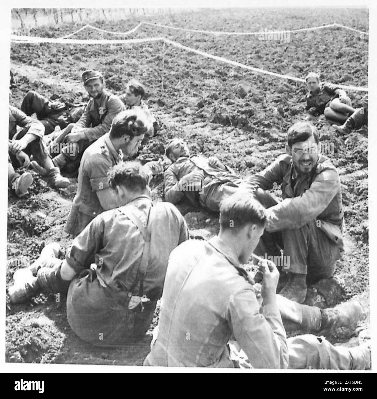 Prisoners captured by the 43rd Gurkha Regiment rest in a temporary POW ...