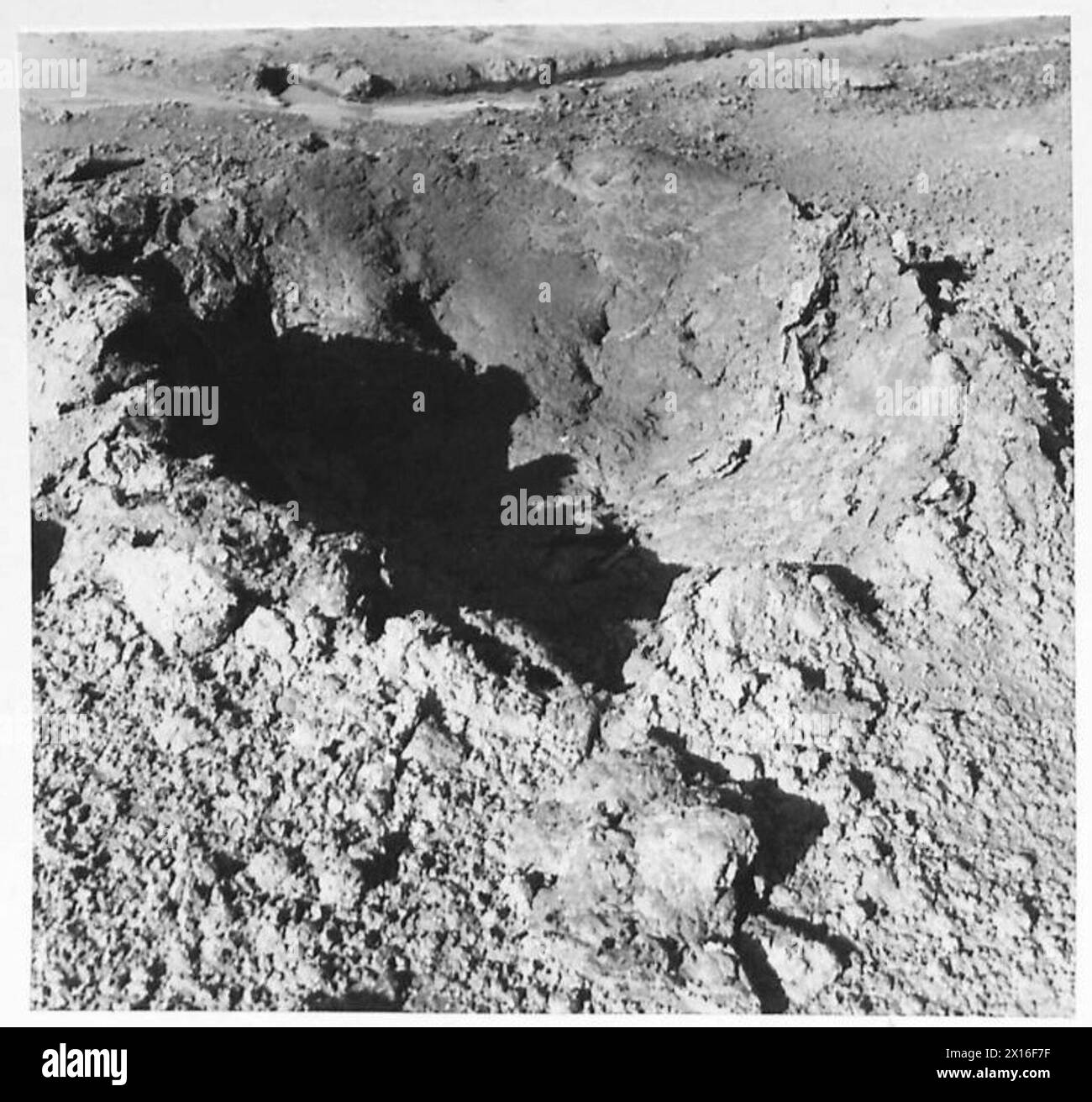 A 25-pounder shell creates a crater in clay during a special assignment ...