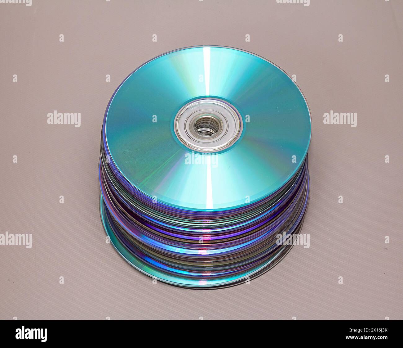 Stack of CD discs on table with white background Stock Photo