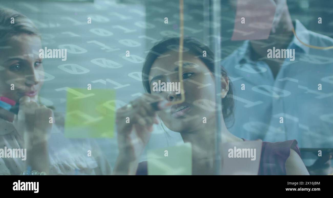 Image of binary coding over diverse business people taking notes Stock Photo