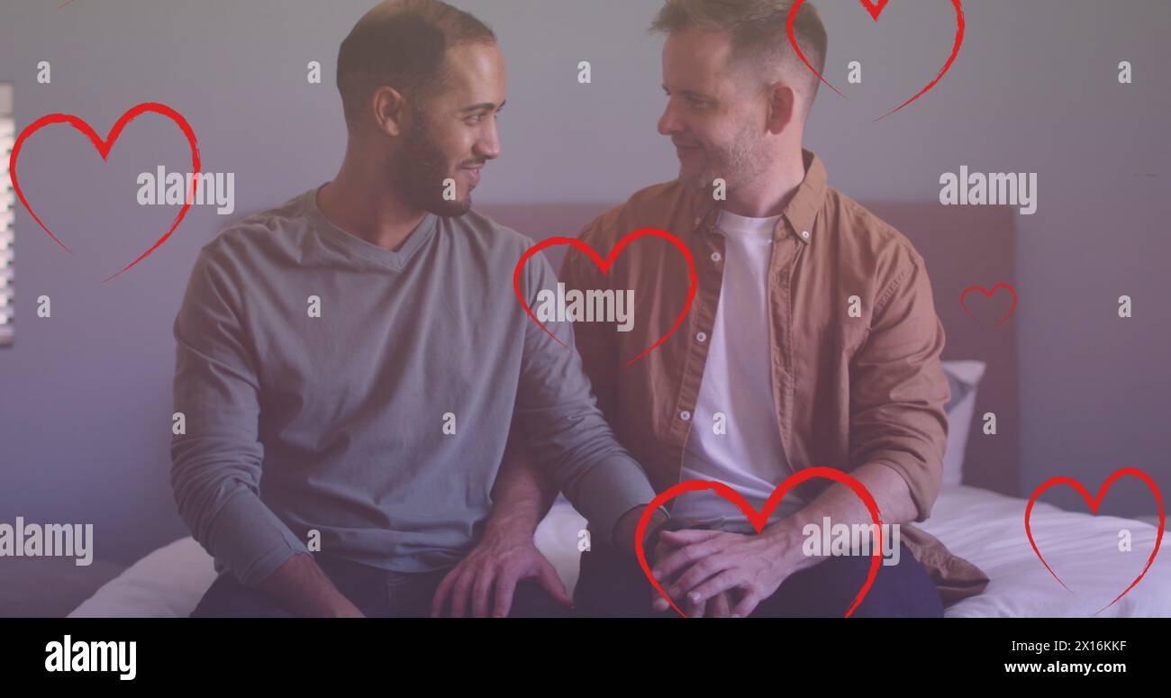 Image of heart icons over diverse gay couple embracing Stock Photo