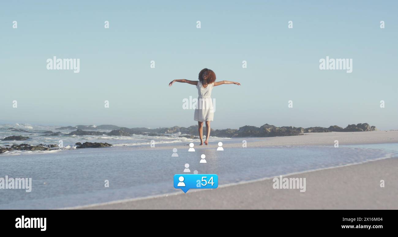Image of stars over african american woman raising hands at beach Stock ...