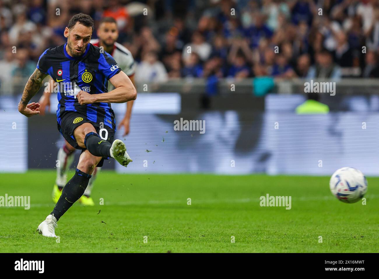 Milan, Italy. 14th Apr, 2024. Hakan Calhanoglu of FC Internazionale scores a penalty during the Serie A 2023/24 football match between FC Internazionale and Cagliari Calcio at Giuseppe Meazza Stadium. Final score; Inter 2:2 Cagliari. Credit: SOPA Images Limited/Alamy Live News Stock Photo