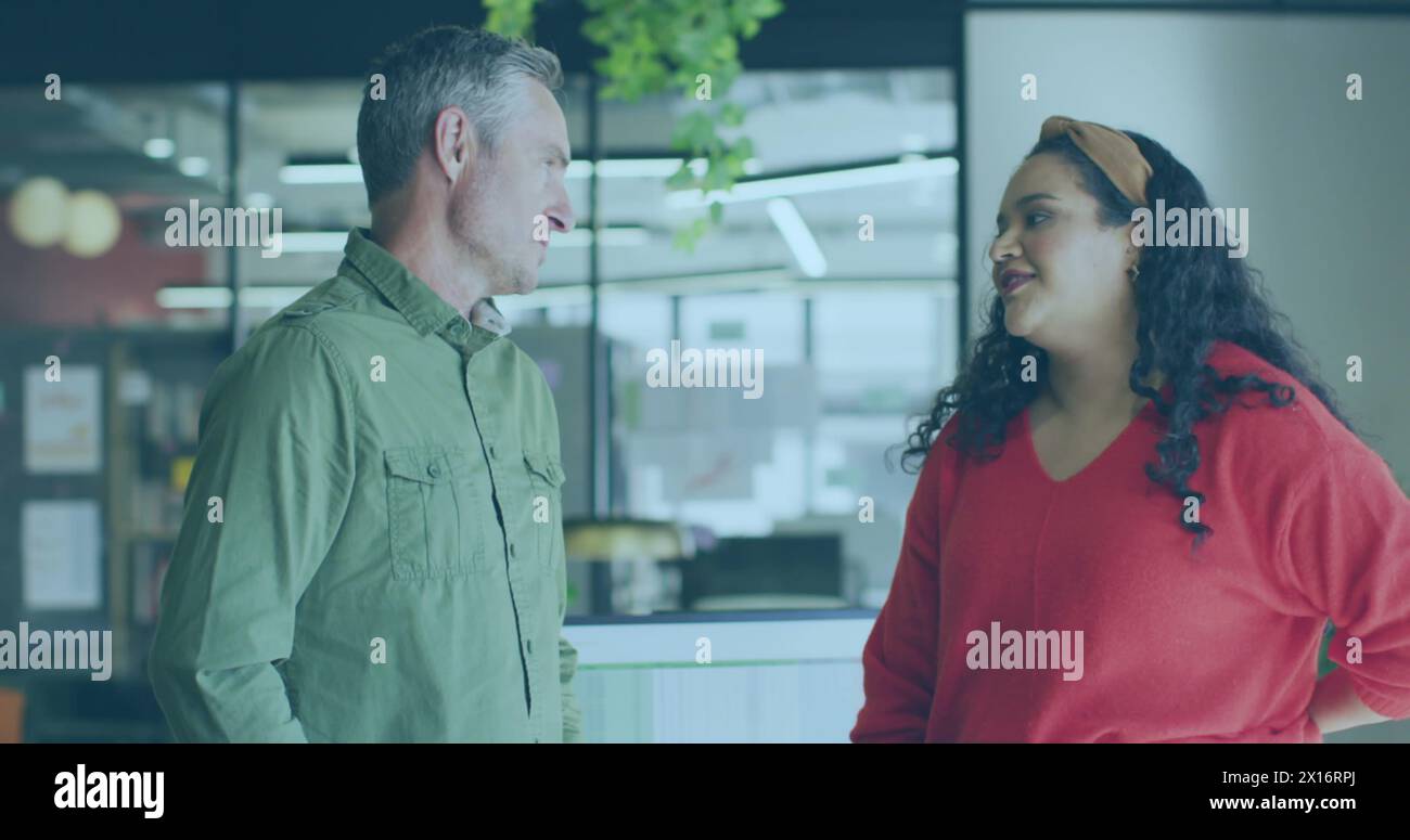 Image of data processing over diverse male and female colleagues discussing at office Stock Photo