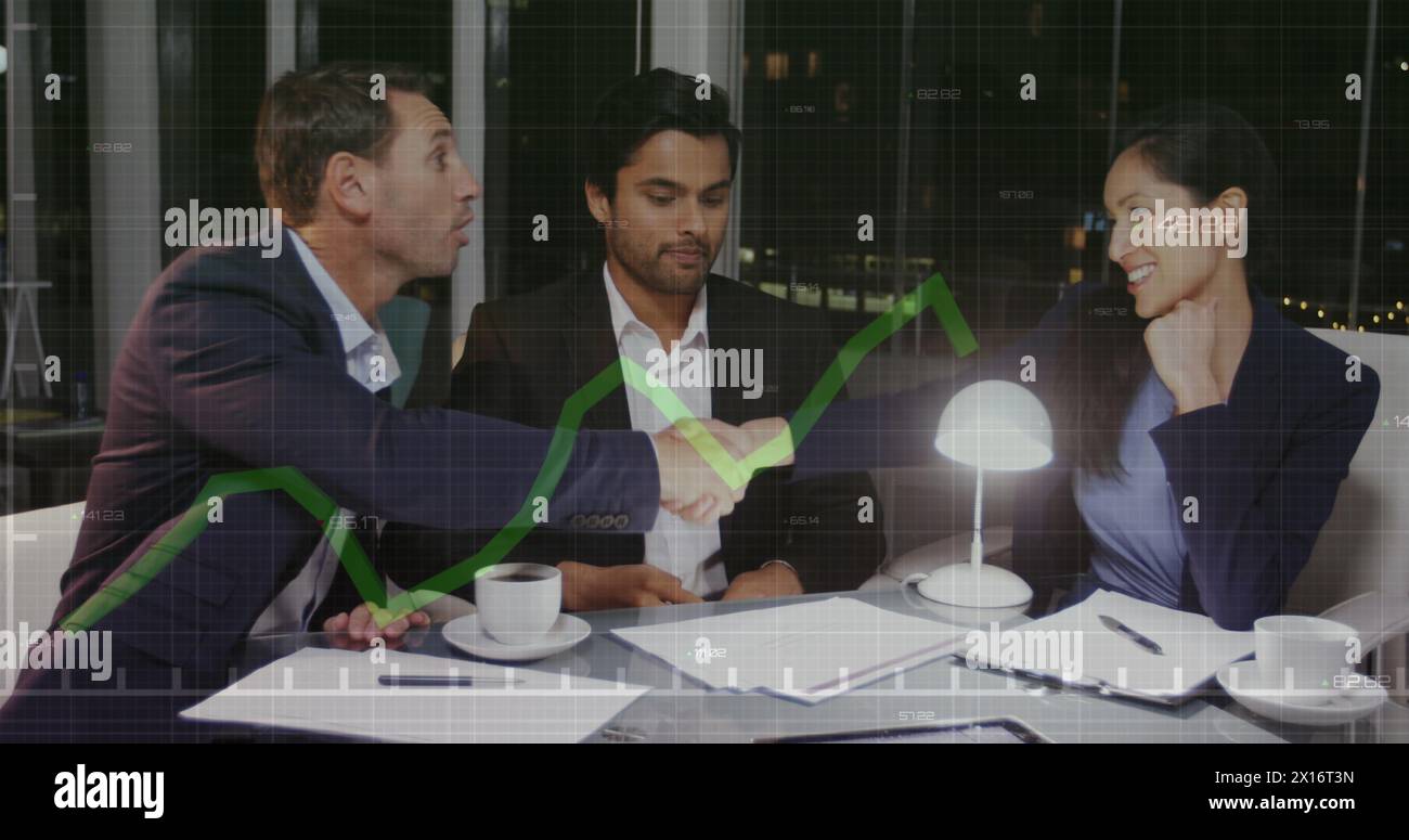 Two business people shaking hands in an office Stock Photo