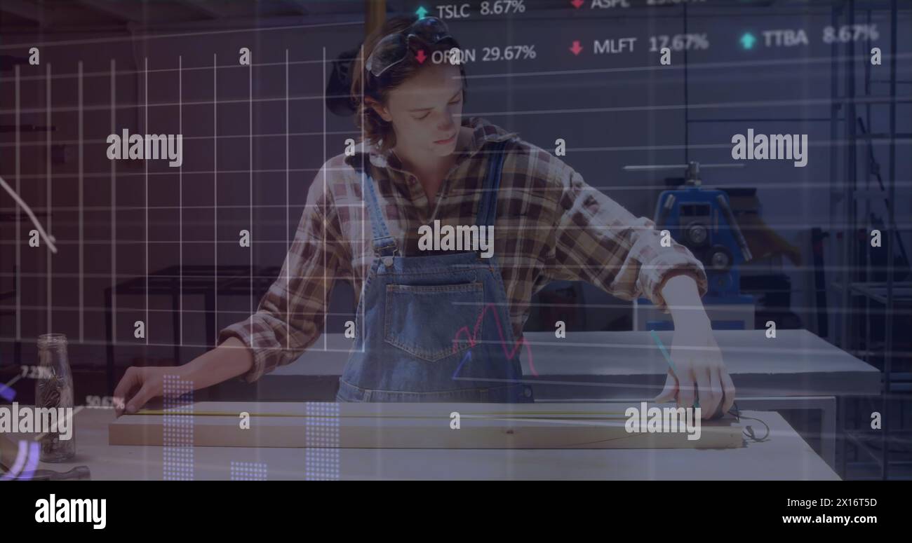 Image of financial data processing over woman working in workshop Stock Photo