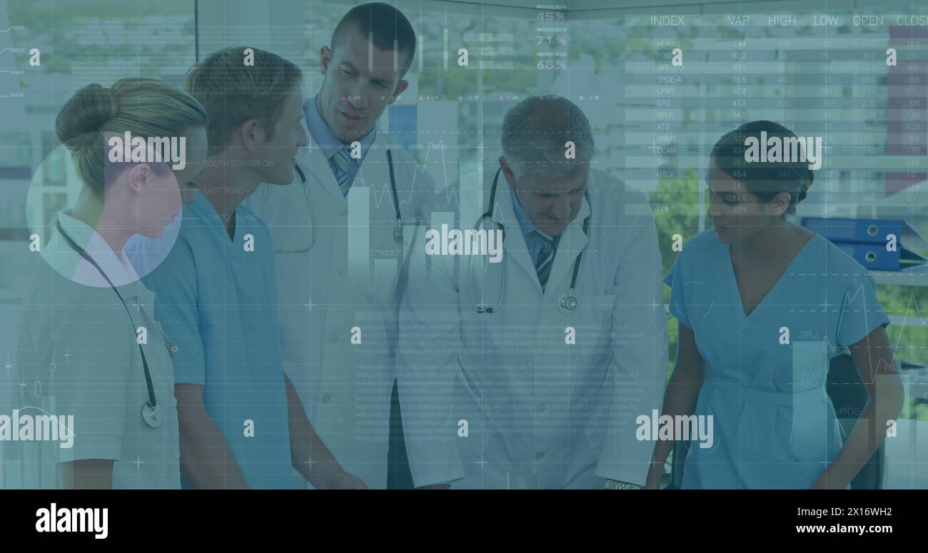 Image of data processing over team of diverse doctors and health workers discussing at hospital Stock Photo