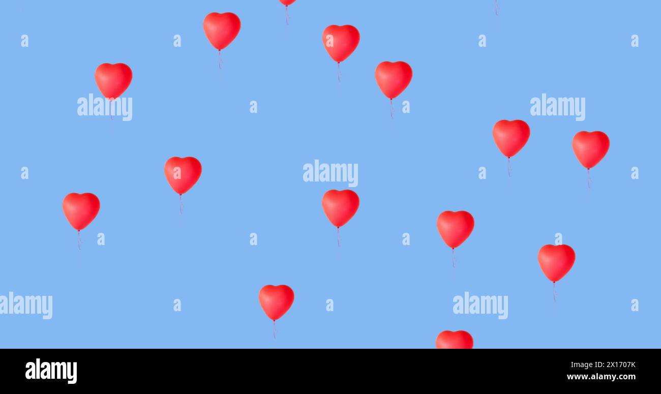 Digital image of multiple red heart shaped balloons floating against ...