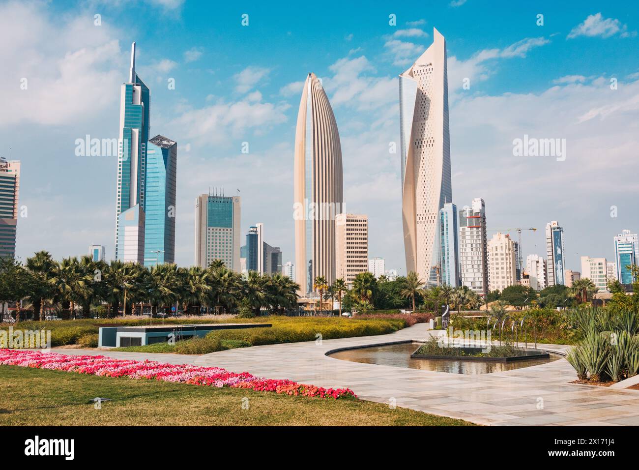 Skyscrapers in the business district of Kuwait City, notably Al Hamra Tower (tallest) and NBK Tower (oval) as seen from Al Shaheed Park Stock Photo