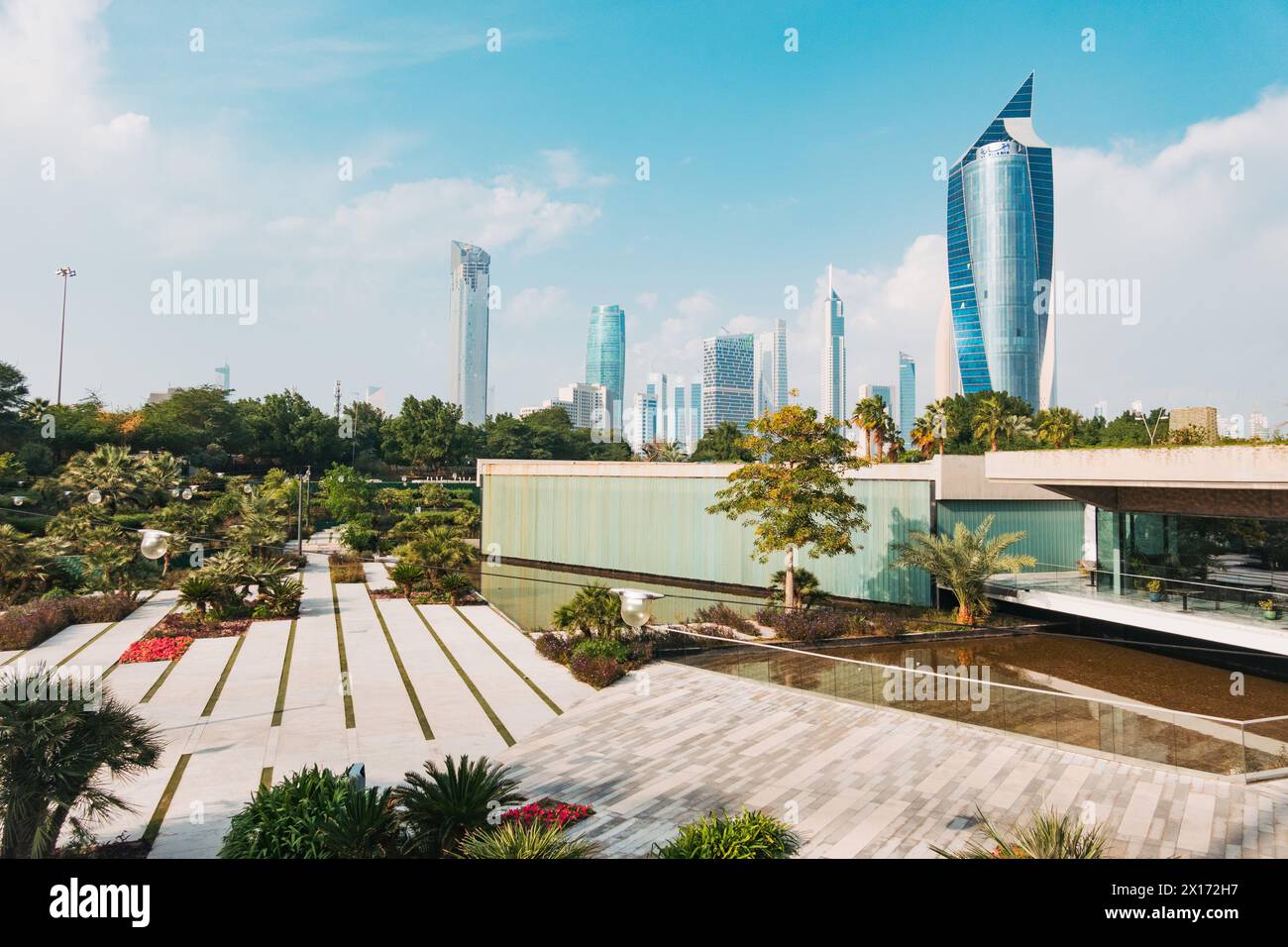 The Al Tijaria Tower looms over Al Shaheed Park in Kuwait City, Kuwait Stock Photo