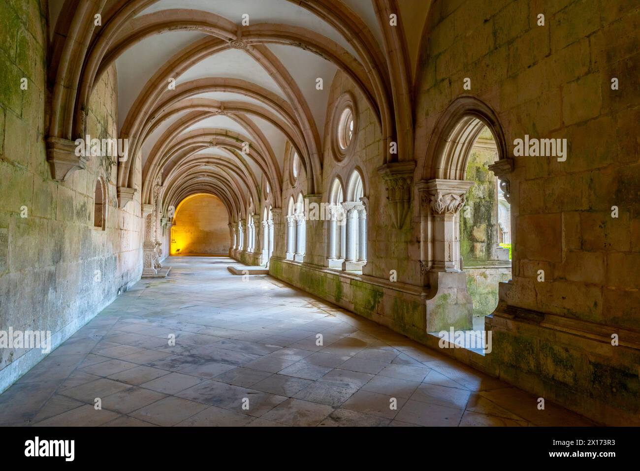 Vaulted passageways in the cloister. The Alcobaça Monastery (Mosteiro de Alcobaça)  or Alcobasa Monastery  is a Catholic monastic complex located in t Stock Photo
