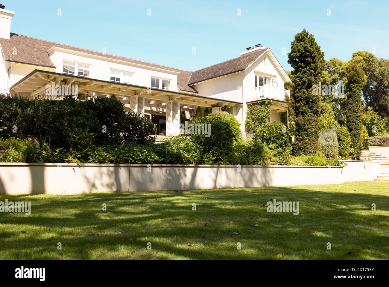 A large house with spacious lawn and greenery at home Stock Photo