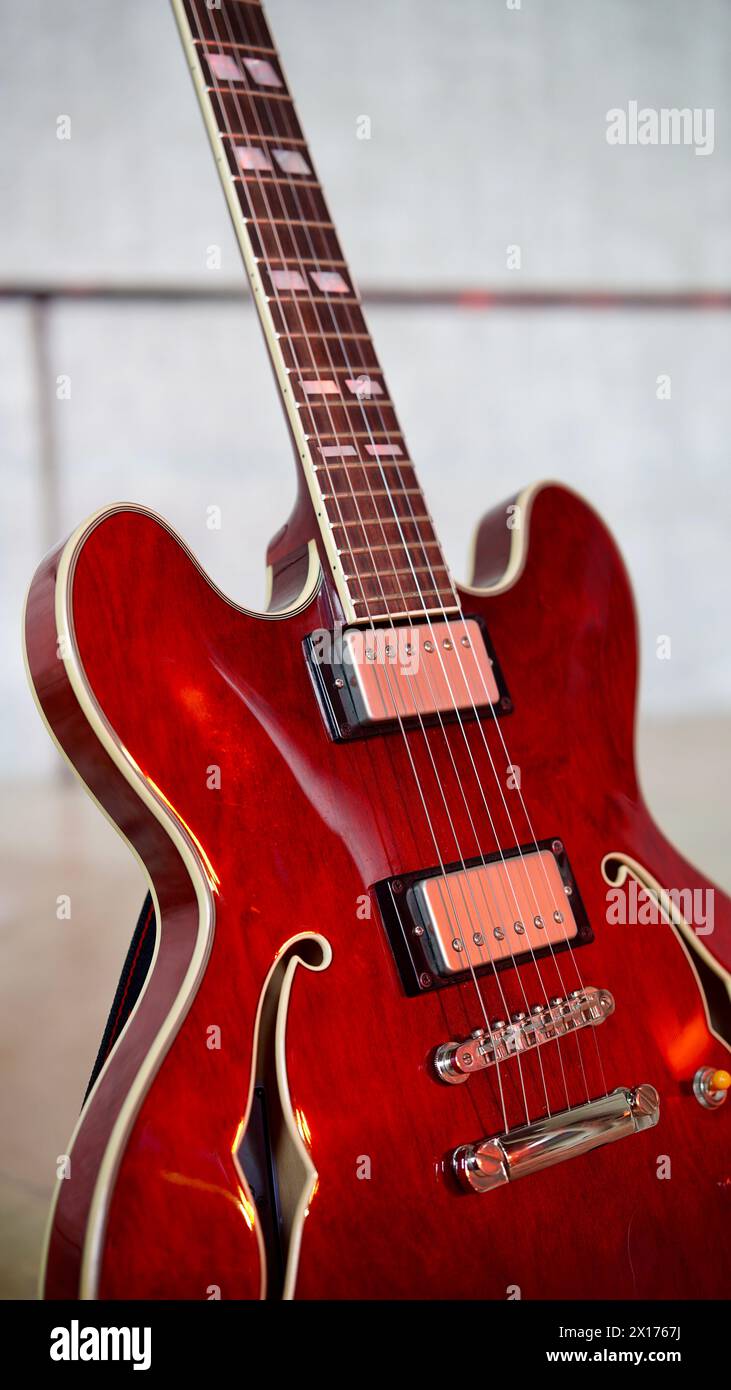 Detail of a red guitar on stage. Stock Photo