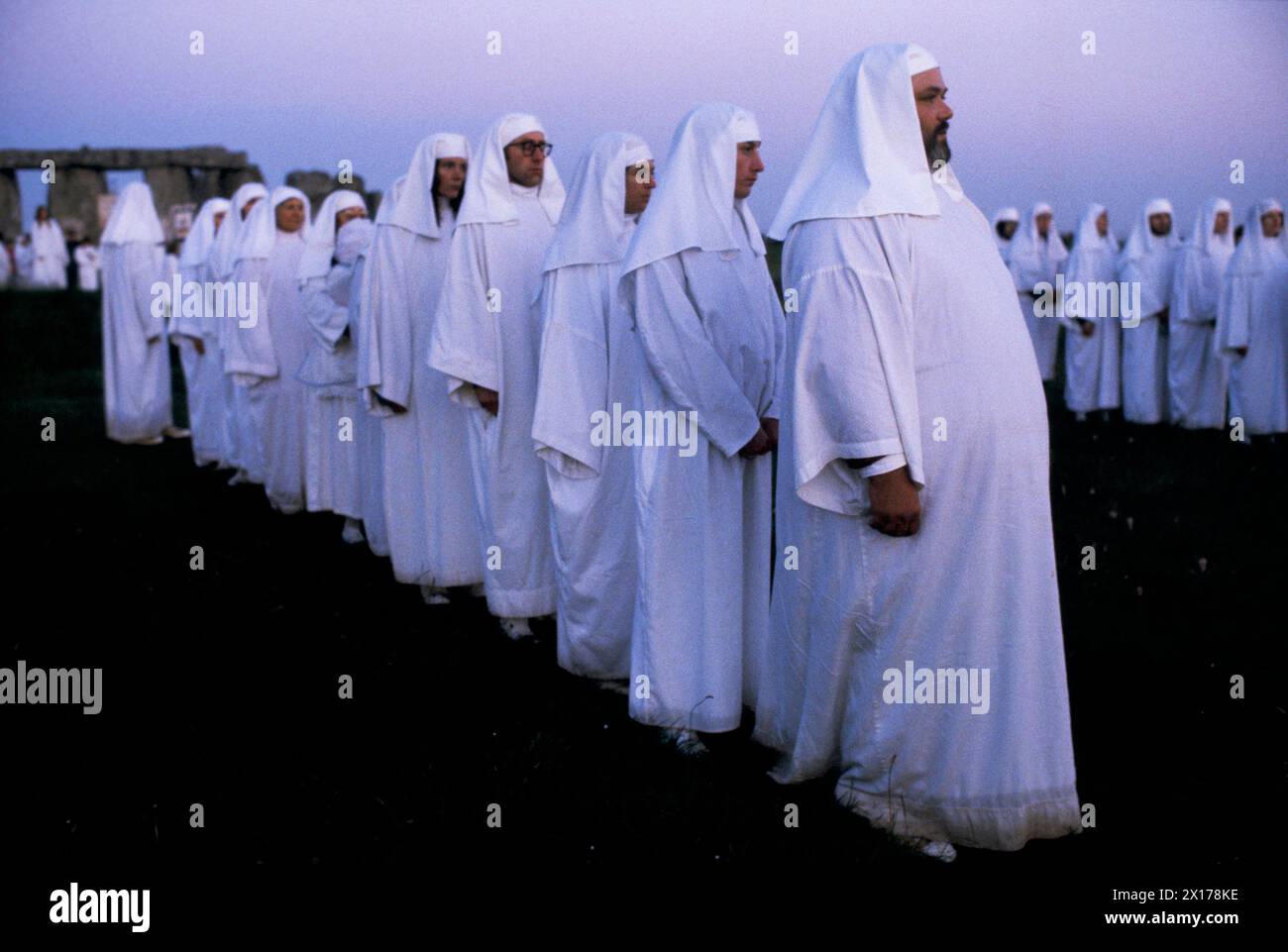 Summer solstice June 21st 1970s UK. Druids gather at Stonehenge an ancient prehistoric monument. They gather the night before and perform old druidic pagan rituals throughout the night. Salisbury Plain. Wiltshire England. Circa 1975 HOMER SYKES Stock Photo