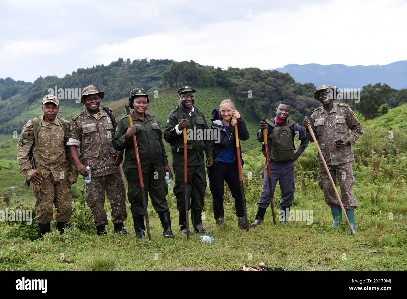 In a heartwarming moment captured for posterity, a diverse group of individuals, including a delighted tourist and several jubilant Bwindi workers, po Stock Photo