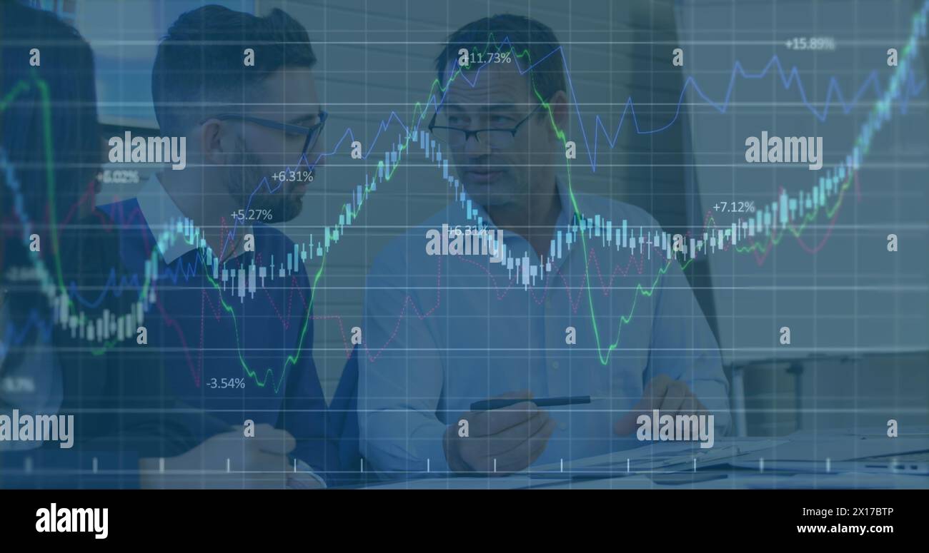 Image of financial data processing over two diverse businessmen discussing at office Stock Photo
