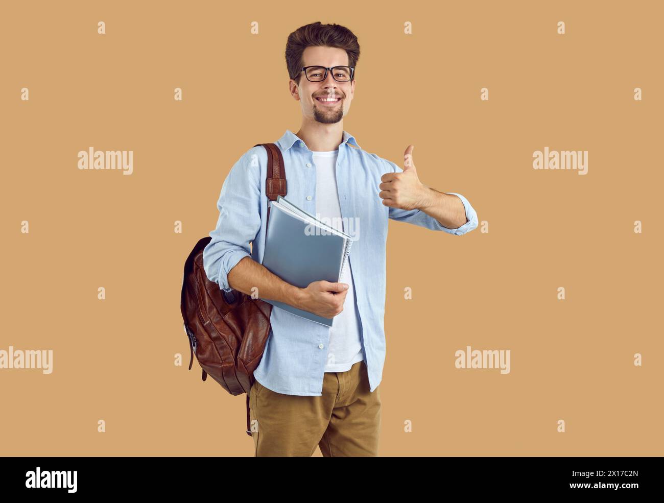 Portrait handsome, smiling student with glasses, dressed in casual ...