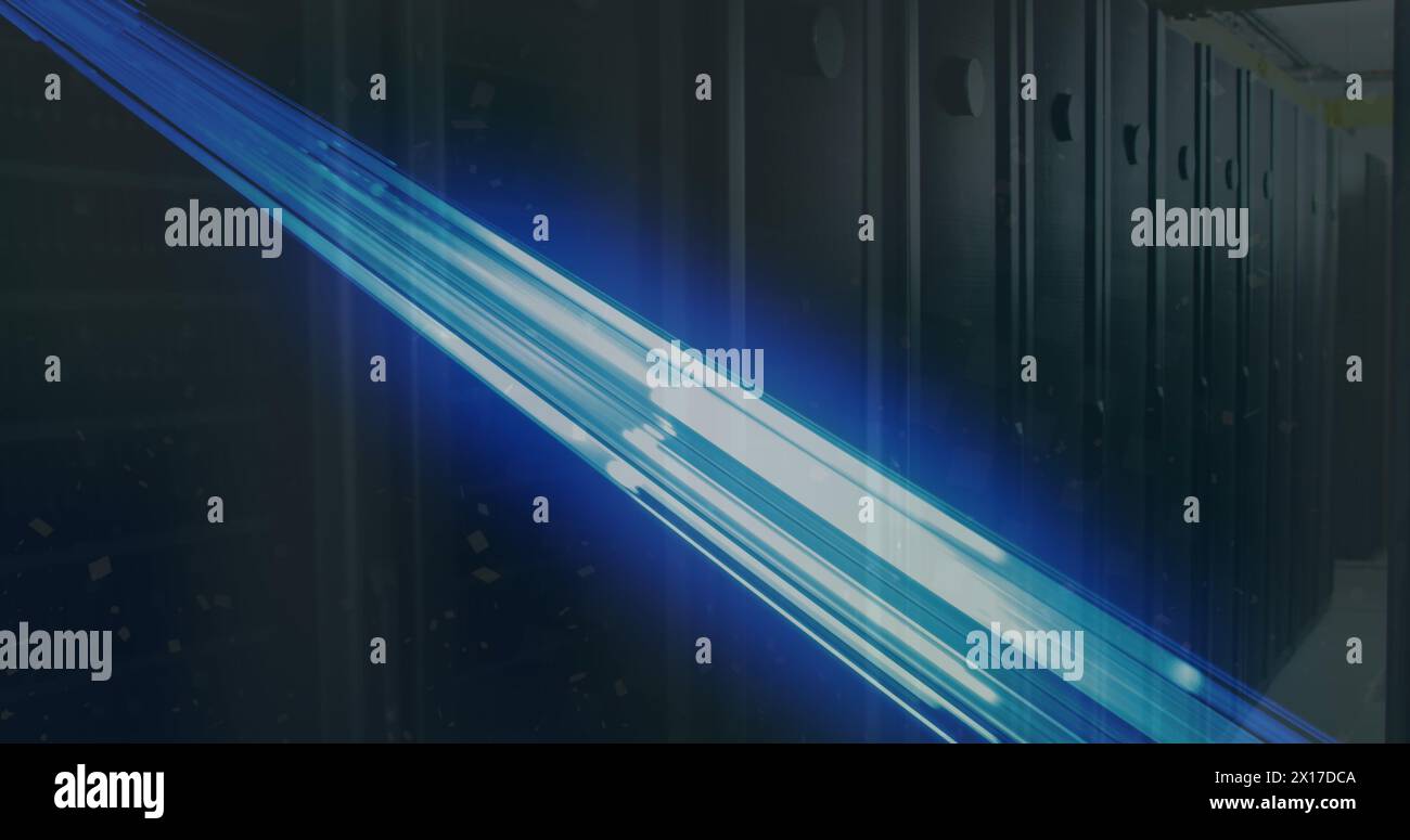 Image of glowing blue light trails over empty computer server room Stock Photo