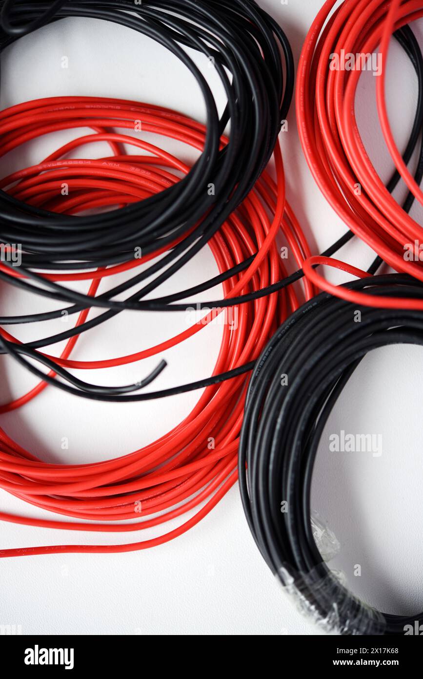 Wires for electronics on a white background. Two coils of red and black wires Stock Photo Alamy