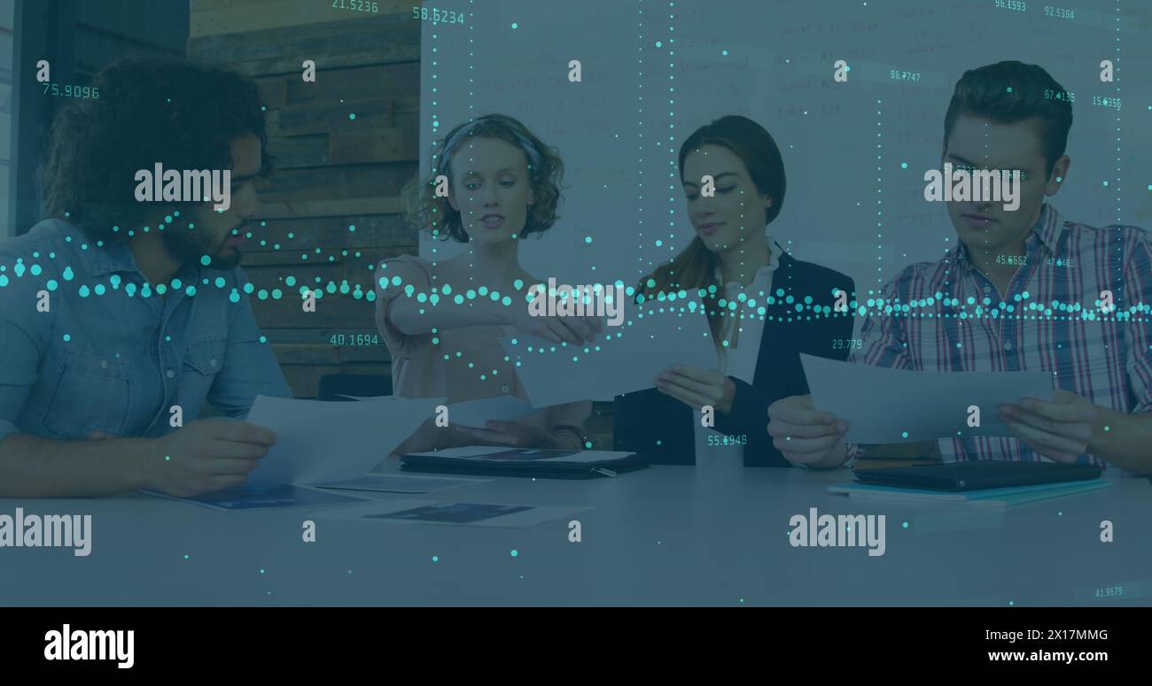 Image of data processing over diverse colleagues discussing over documents at office Stock Photo