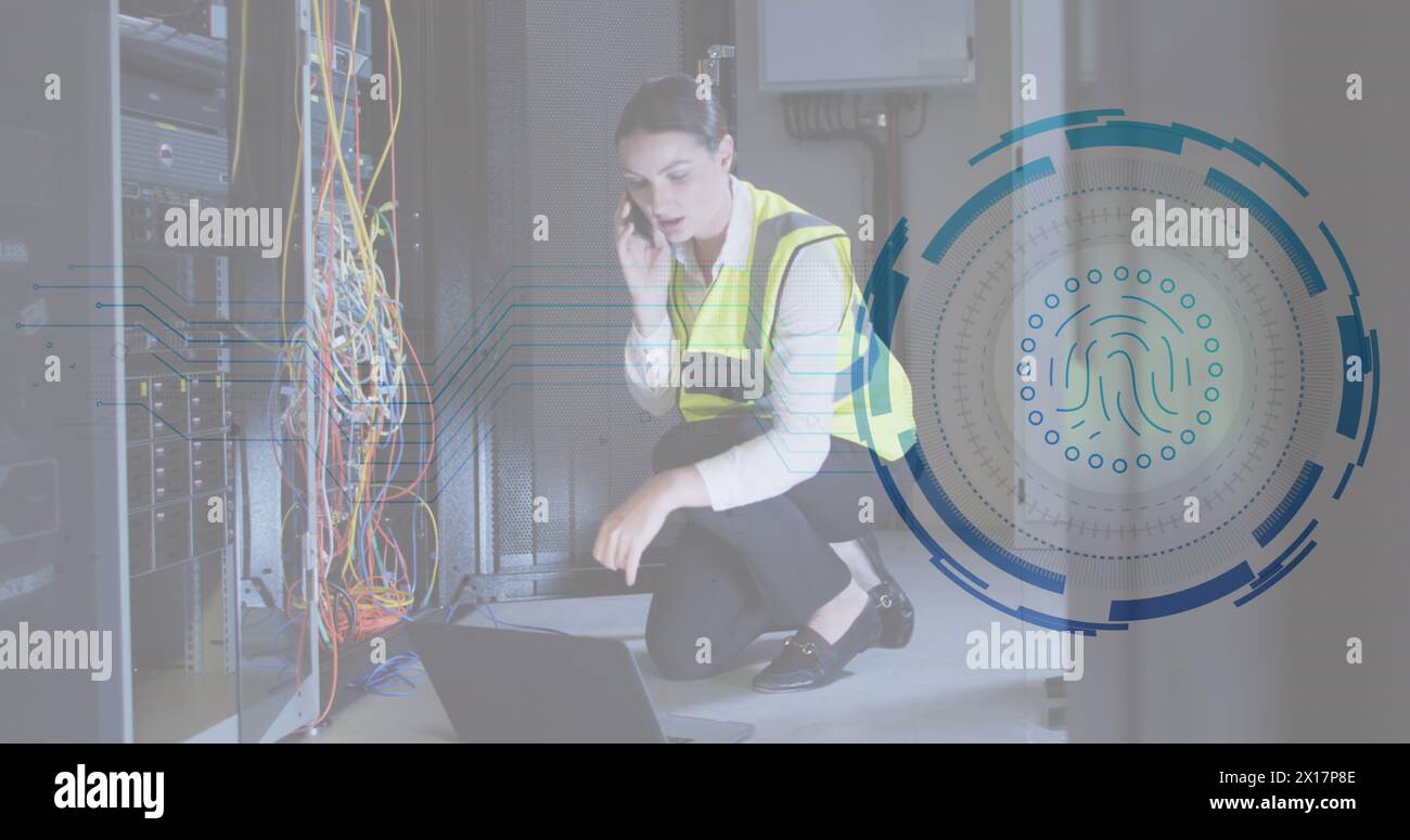 Image of fingerprint scanner over caucasian female engineer talking on smartphone at server room Stock Photo