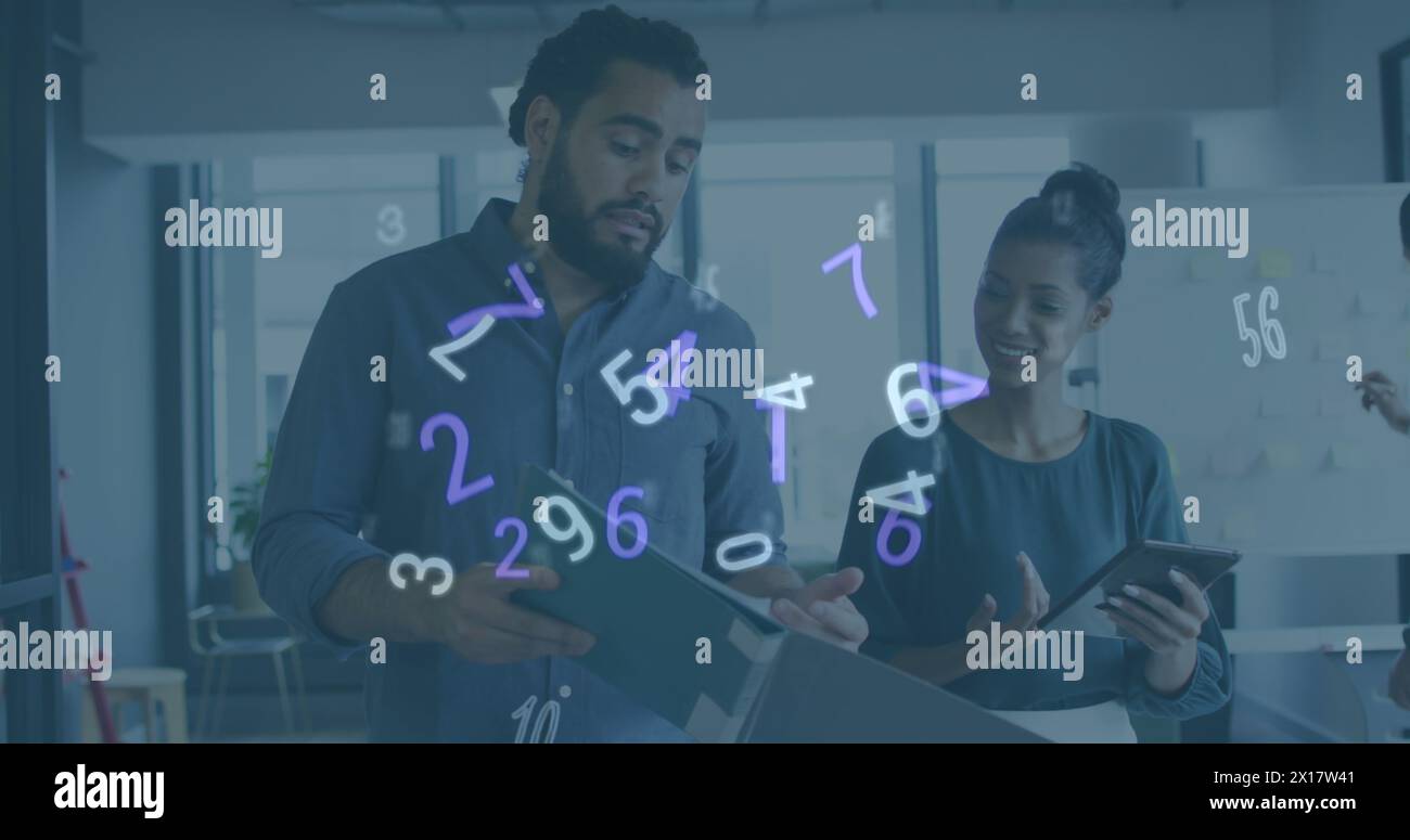 Image of numeric data processing over diverse creative business colleagues using tablet talking Stock Photo