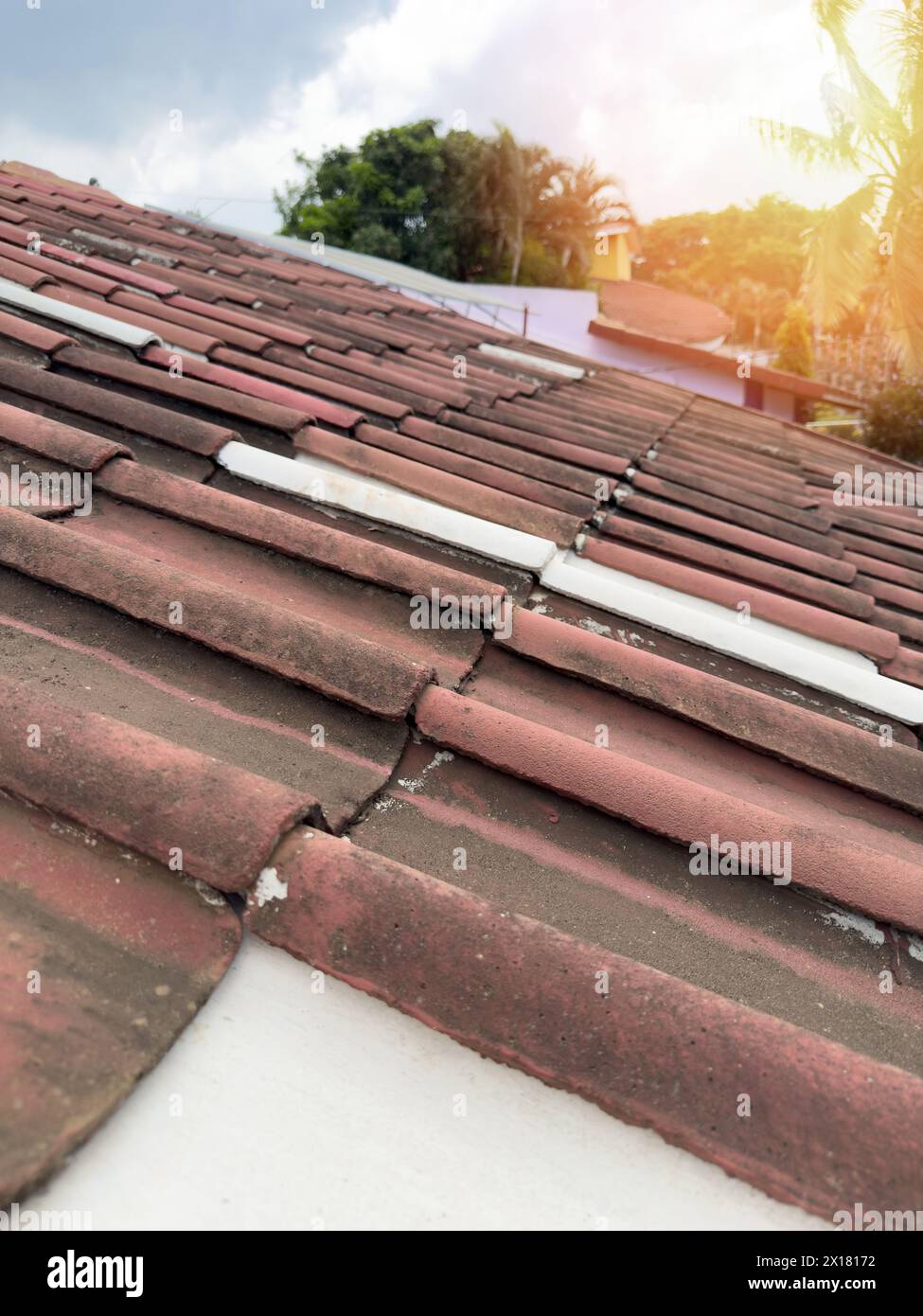 Home roof tiles on sunny sky background close up view Stock Photo