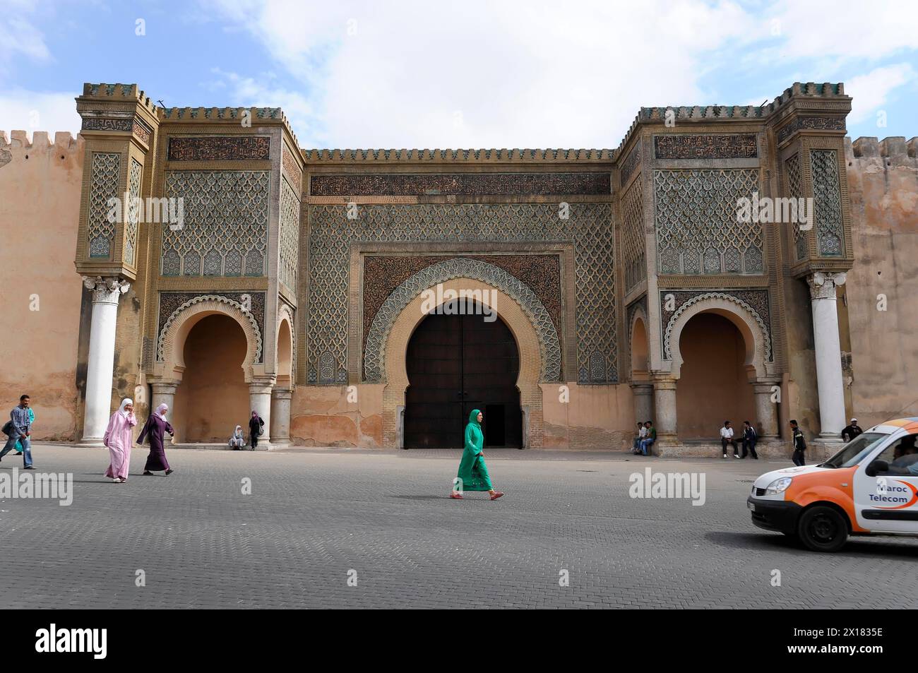 Bab Mansour city gate, Meknes, View of the Bab Mansour gate in Meknes with passers-by and clear sky, Northern Morocco, Morocco Stock Photo