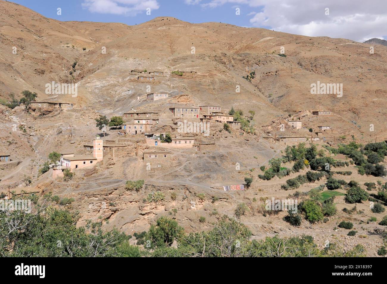 A remote mountain village with traditional houses nestled in hilly terrain, Southern High Atlas, Morocco Stock Photo