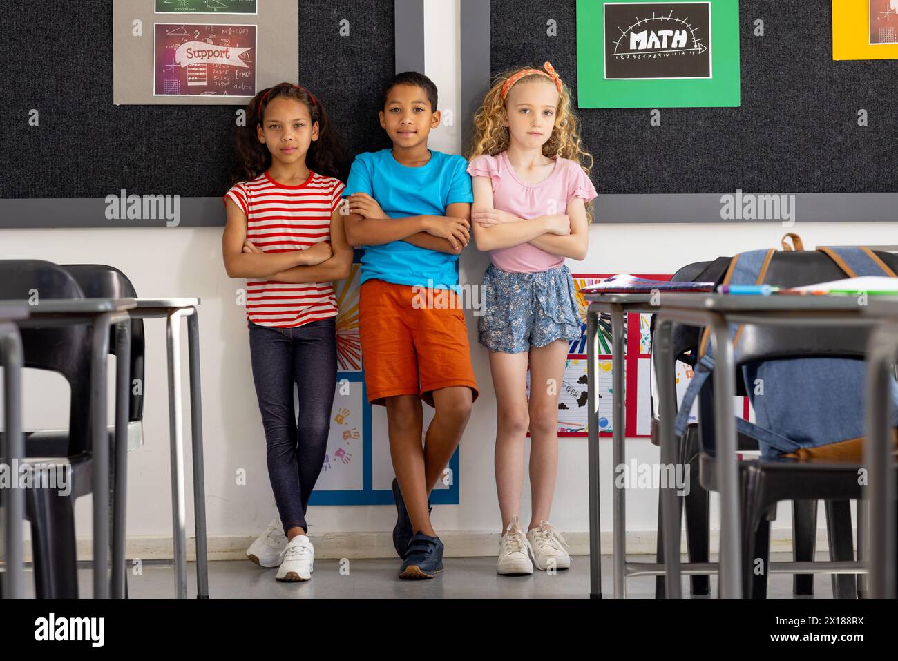 In school, diverse group of young students standing together in the ...