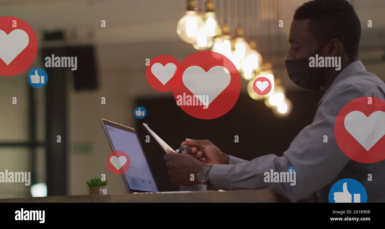 Image of floating application icons over multiracial coworkers discussing over laptop Stock Photo