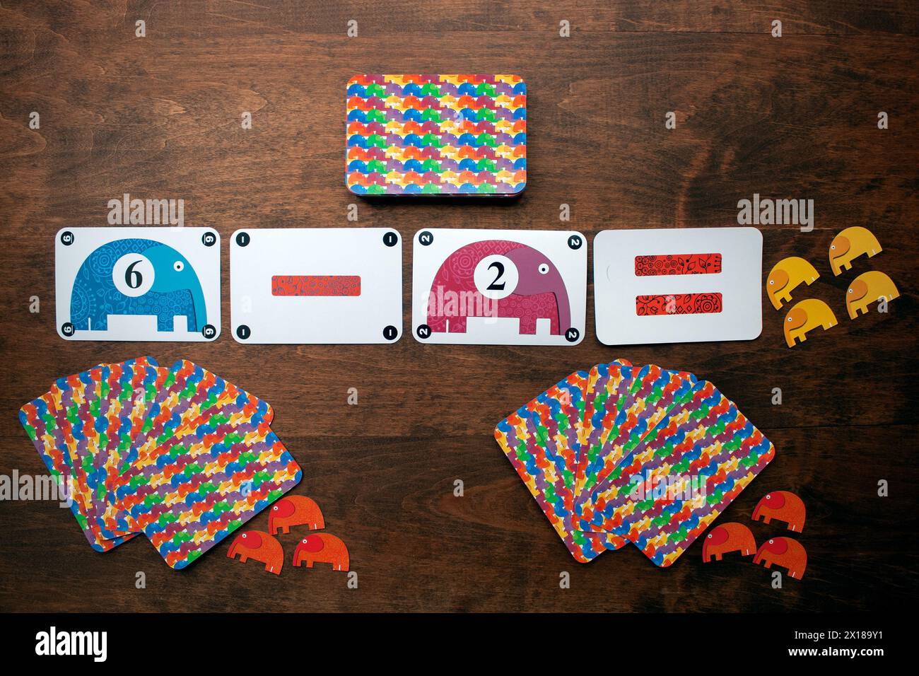 Minsk, Belarus - 24 October 2014: Djeco math board game. Cards with mathematical signs, numbers and elephants on a wooden table Stock Photo