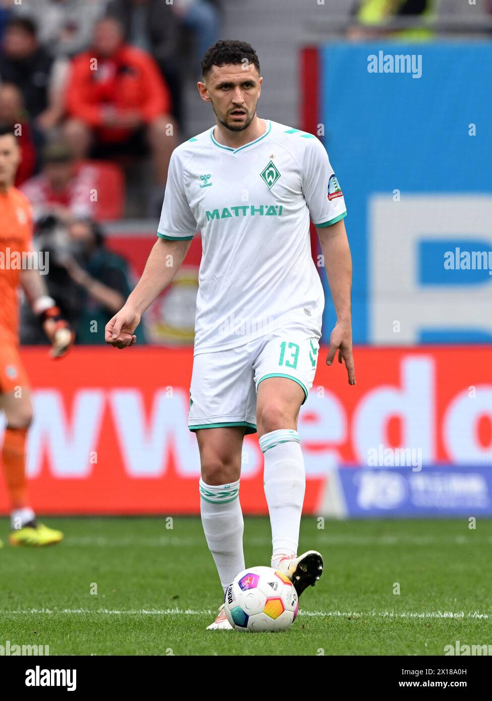 LEVERKUSEN - Milos Veljkovic of SV Werder Bremen during the Bundesliga match between Bayer 04 Leverkusen and Werder Bremen at the Bay Arena on April 14, 2024 in Leverkusen, Germany. ANP | Hollandse Hoogte | GERRIT VAN COLOGNE Stock Photo