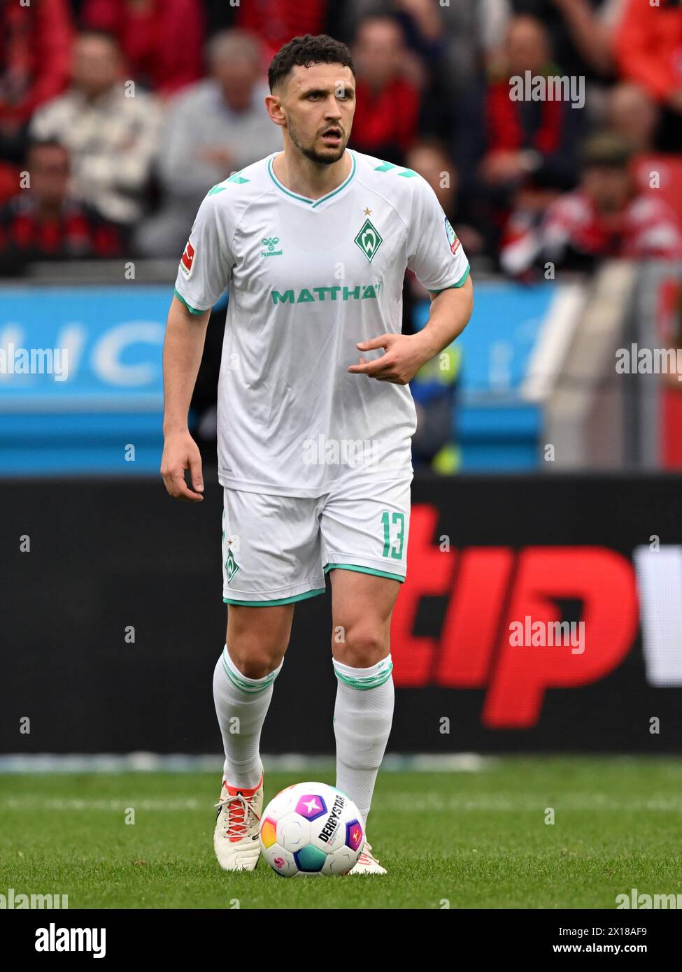 LEVERKUSEN - Milos Veljkovic of SV Werder Bremen during the Bundesliga match between Bayer 04 Leverkusen and Werder Bremen at the Bay Arena on April 14, 2024 in Leverkusen, Germany. ANP | Hollandse Hoogte | GERRIT VAN COLOGNE Stock Photo