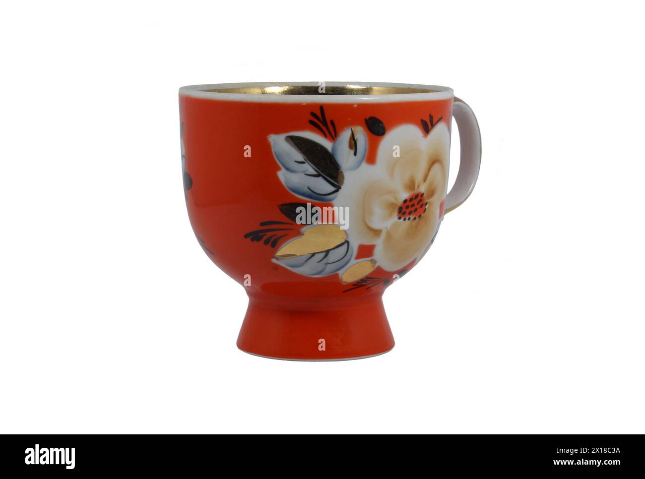 Big red porcelain cup. On cup depicts flowers. Isolated on white Stock Photo