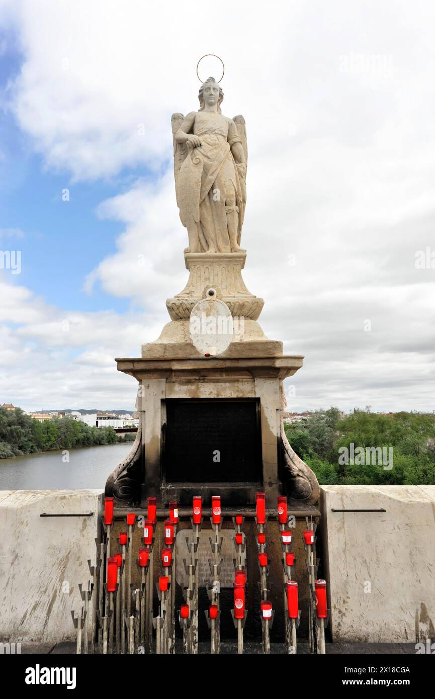 Church figure, Madonna figure, Puente Romano-Puente Viejo, bridge over the Rio Guadalquivir, Cordoba, Religious statue of an angel with candlesticks Stock Photo