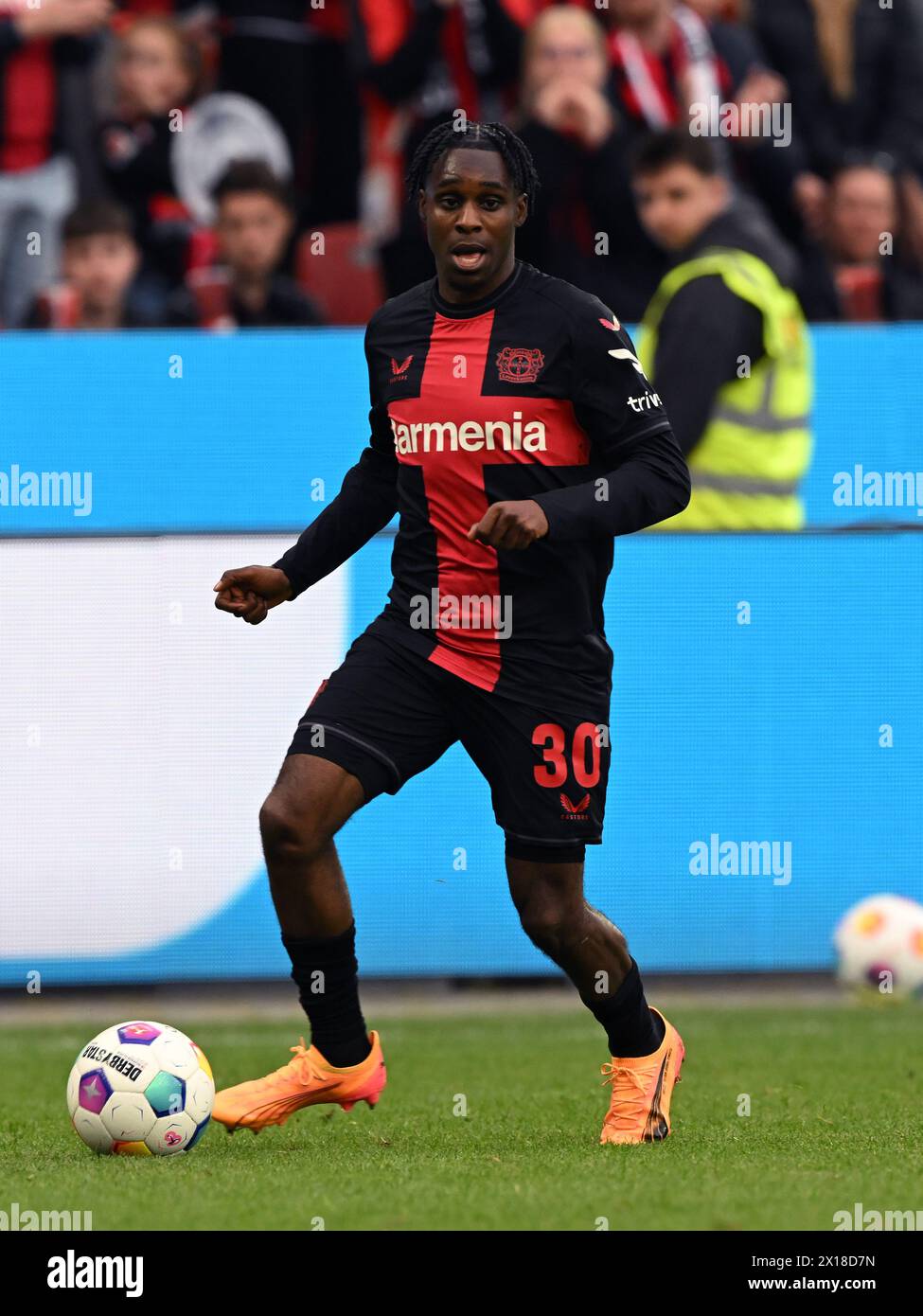 LEVERKUSEN - Jeremie Frimpong of Bayer 04 Leverkusen during the Bundesliga match between Bayer 04 Leverkusen and Werder Bremen at the Bay Arena on April 14, 2024 in Leverkusen, Germany. ANP | Hollandse Hoogte | GERRIT VAN COLOGNE Stock Photo