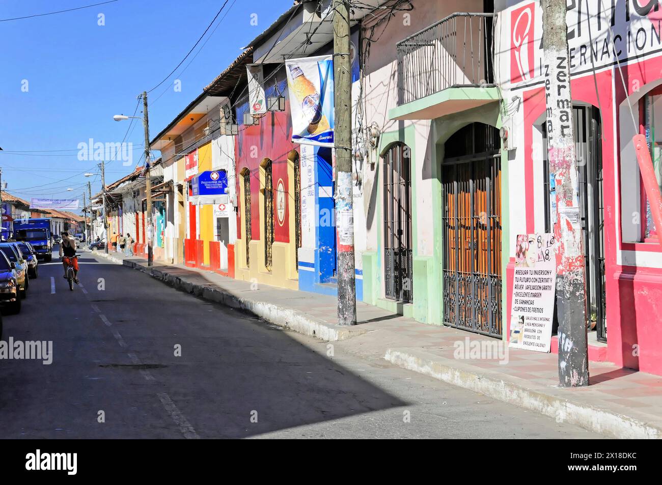 Leon, Nicaragua, Colourful house facades on a sunny, quiet street in a city, Central America, Central America - Stock Photo