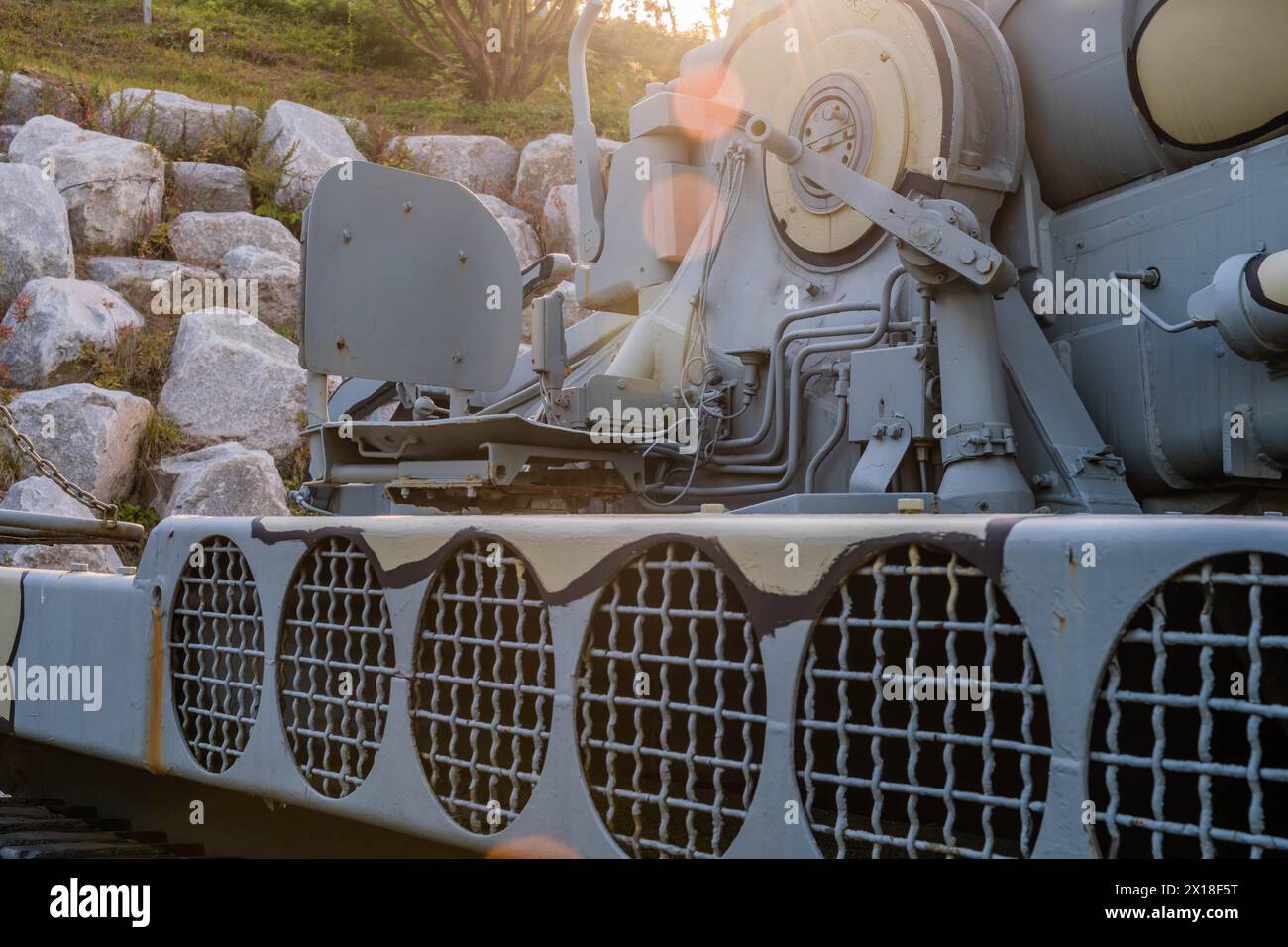 Side view of camouflaged army tank with vents above track and closeup ...