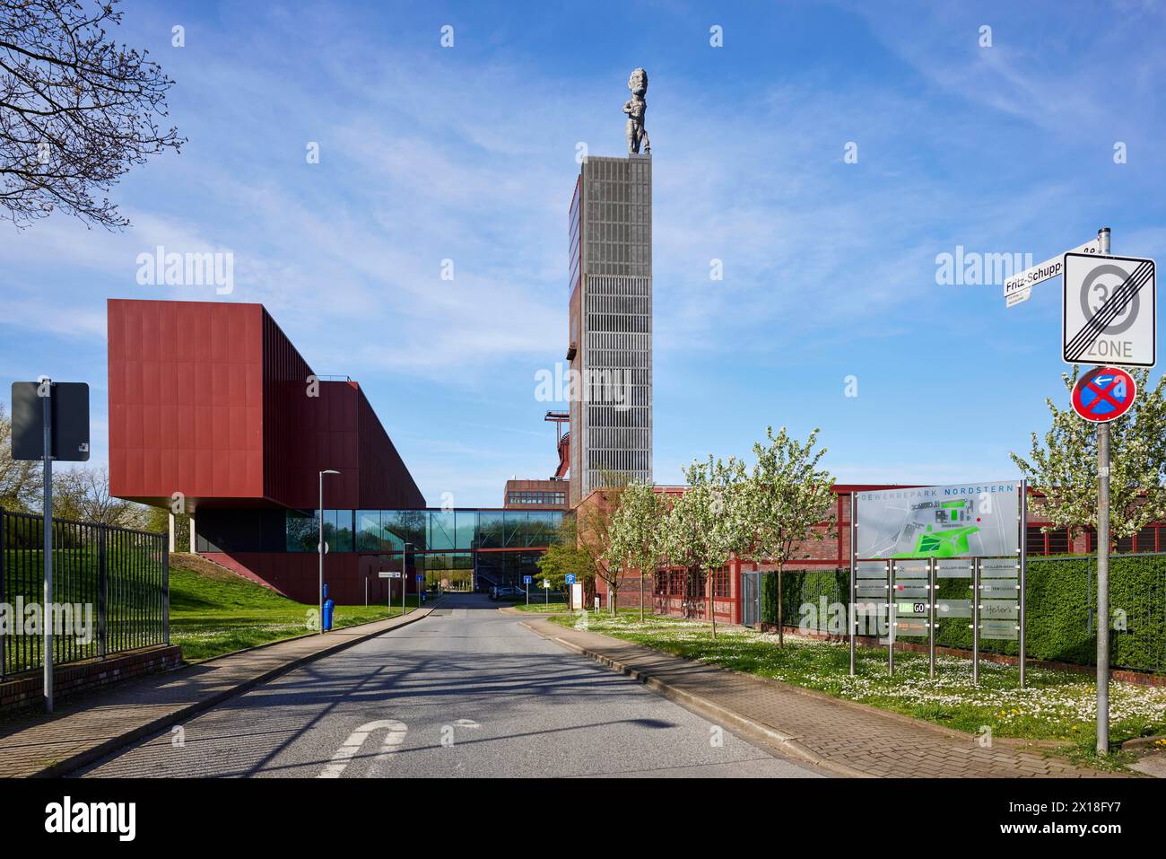 Entrance to the Nordstern industrial park with Fritz-Schupp-Strasse, winding tower of the former Nordstern colliery and Hercules statue in Stock Photo