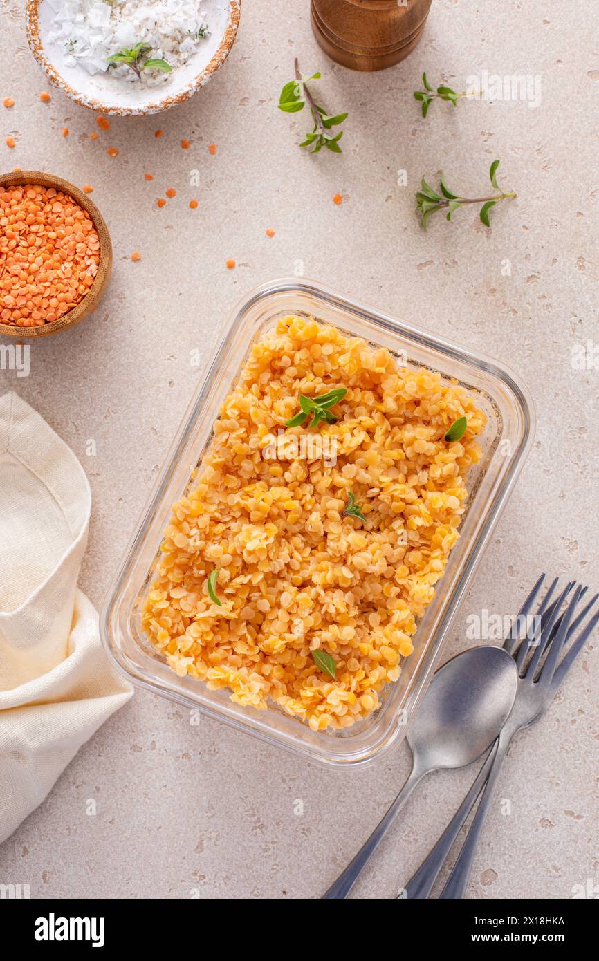 Cooked red lentils in a meal prep container, healthy vegan protein source, meat alternative Stock Photo