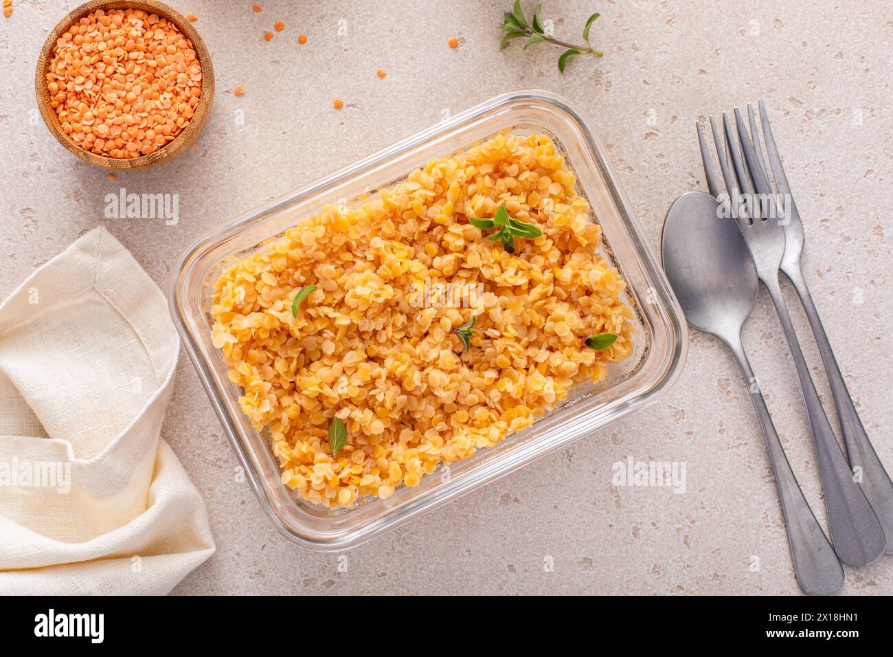 Cooked red lentils in a meal prep container, healthy vegan protein source, meat alternative Stock Photo