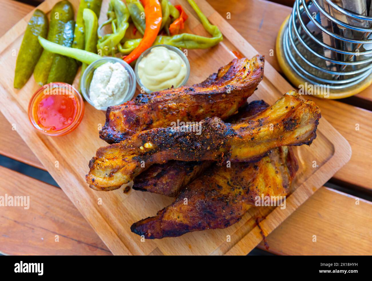 Grilled pork ribs with sauces, pickled vegetables Stock Photo - Alamy