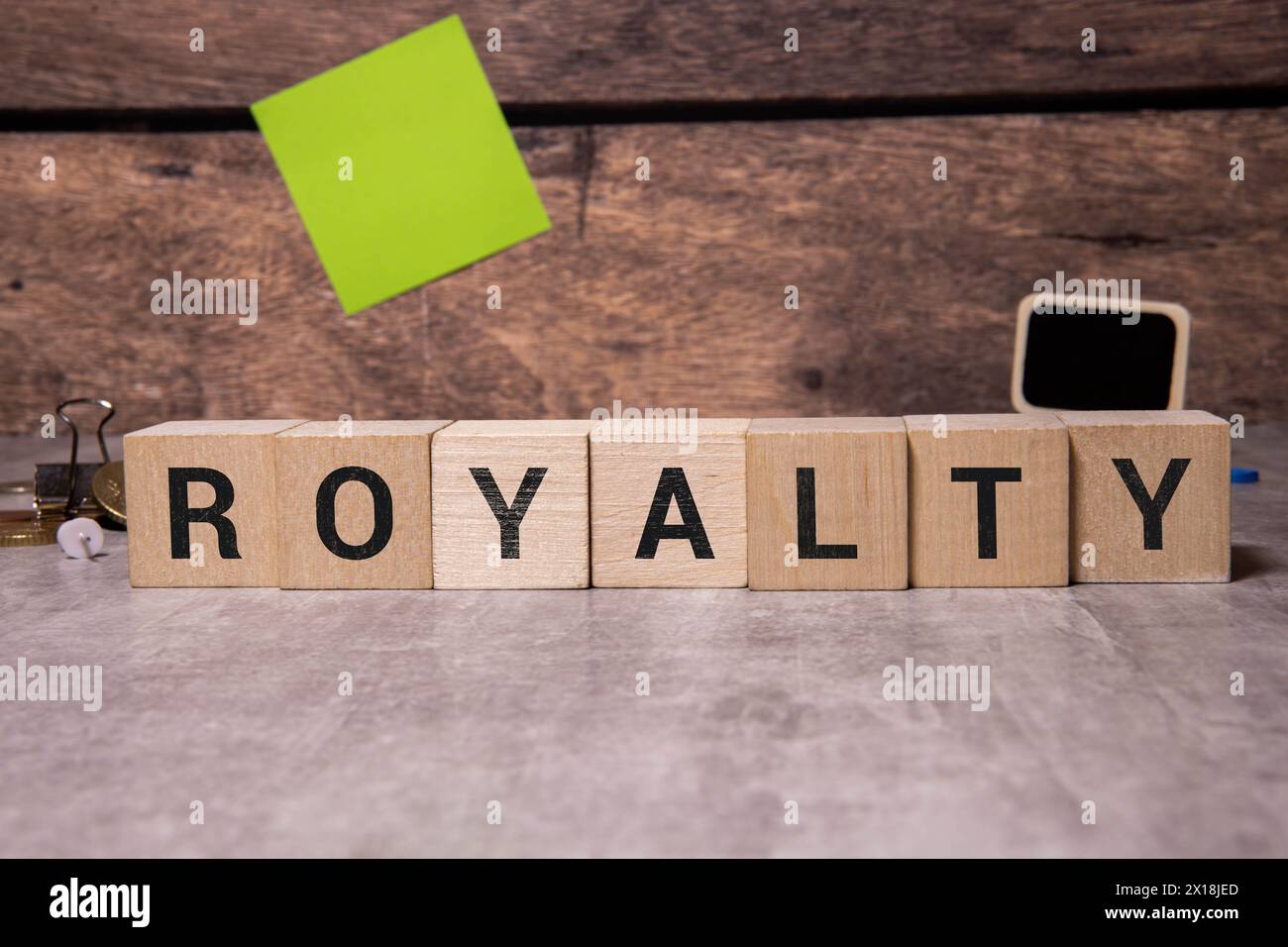 Wooden blocks with ROYALTY text of concept and coins Stock Photo - Alamy