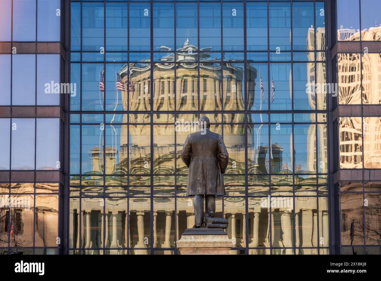 McKinley memorial in front of a reflection of the Ohio state Capitol building in the windows of an office building across the street in Columbus, OH Stock Photo