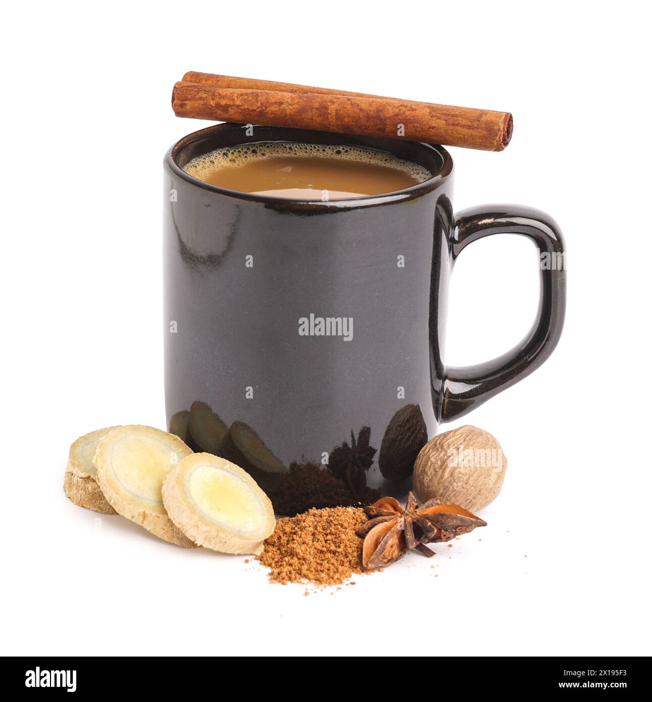 Black cup of delicious masala tea with different spices and walnut on ...