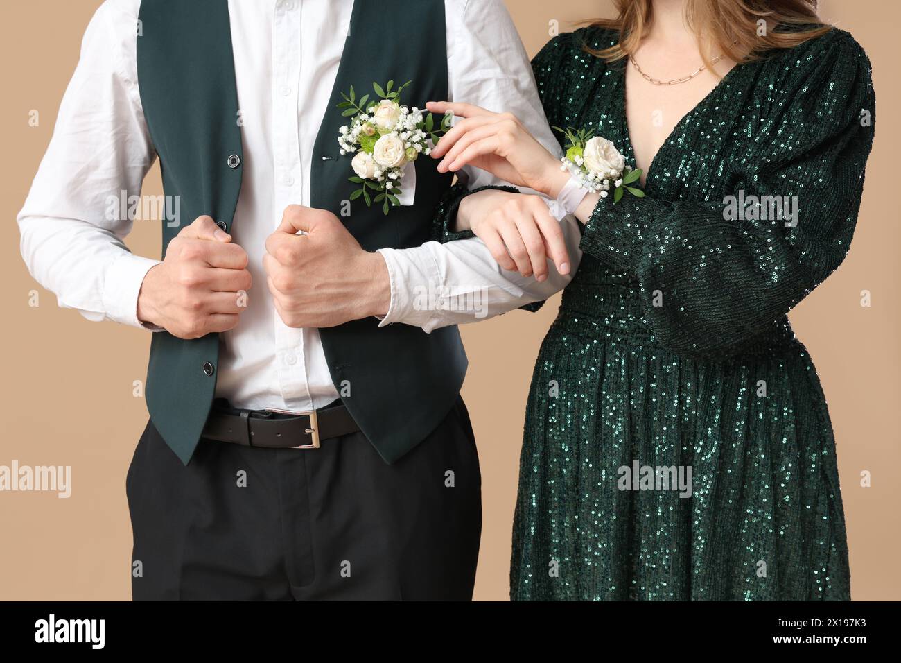 Beautiful couple dressed for prom on beige background Stock Photo