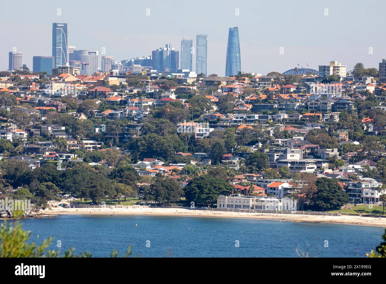 Bathers Pavilion on Balmoral Edwards Beach with suburb housing homes and view of Sydney skyscrapers in the city centre, NSW,Australia Stock Photo
