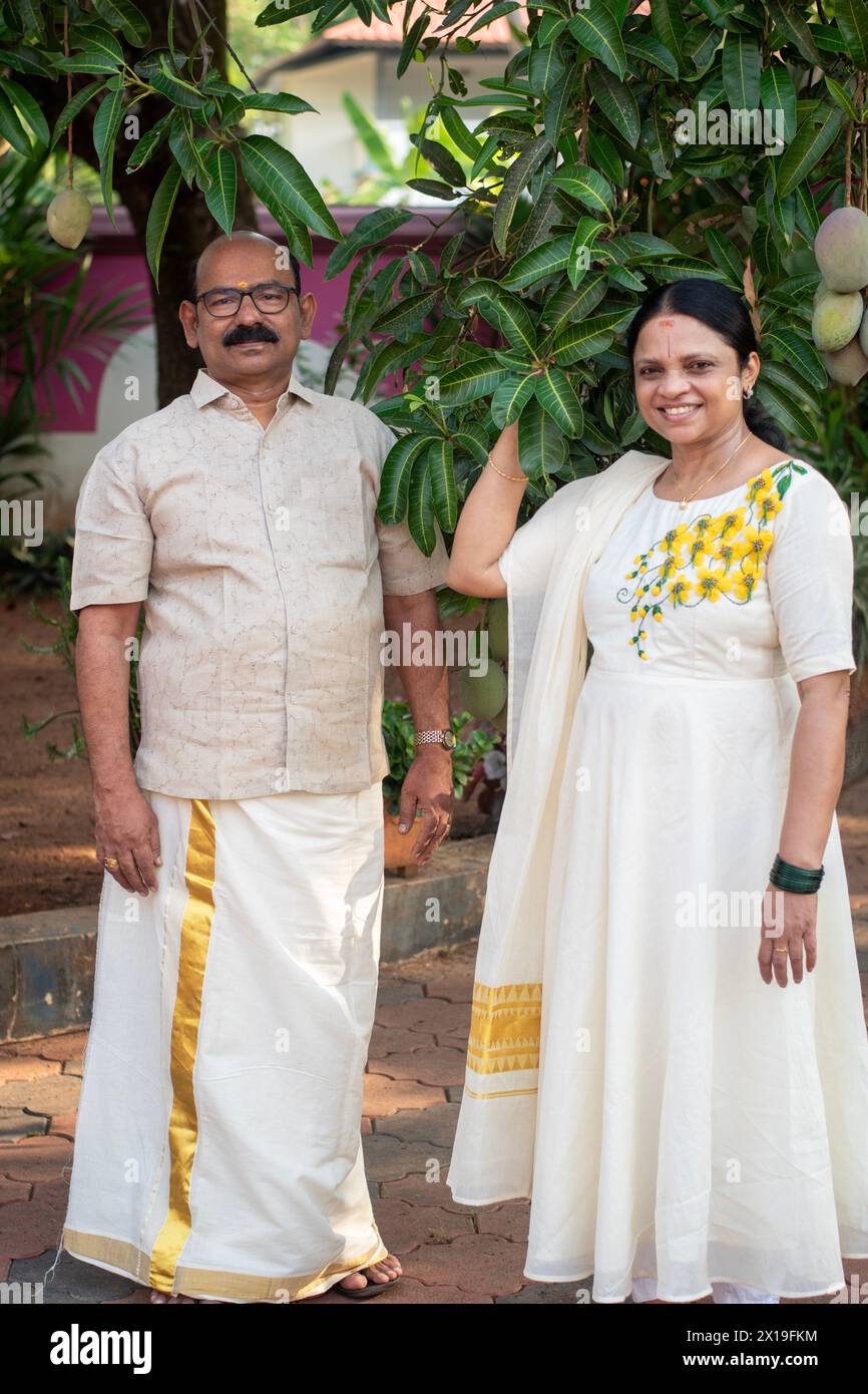 A Picture of middle aged malayali man and woman wearing a traditional kerala clothing Stock Photo