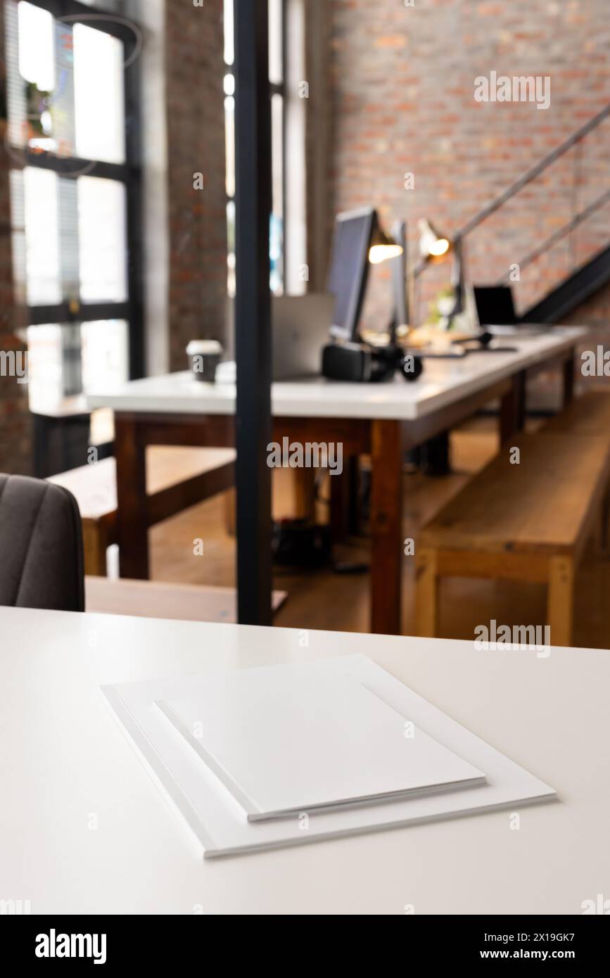 Large copy space, focus on white canvas on a table in a well-lit, modern business office workspace Stock Photo